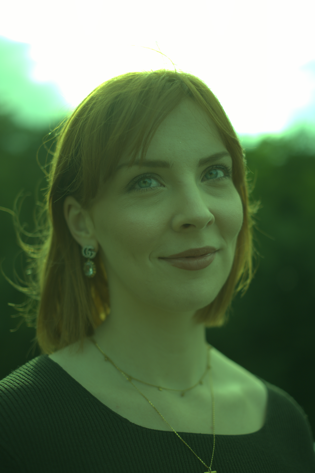 A colour version of the portrait, but with a heavy green cast across the entire frame; skin tones look sickly and the overall contrast is muted.